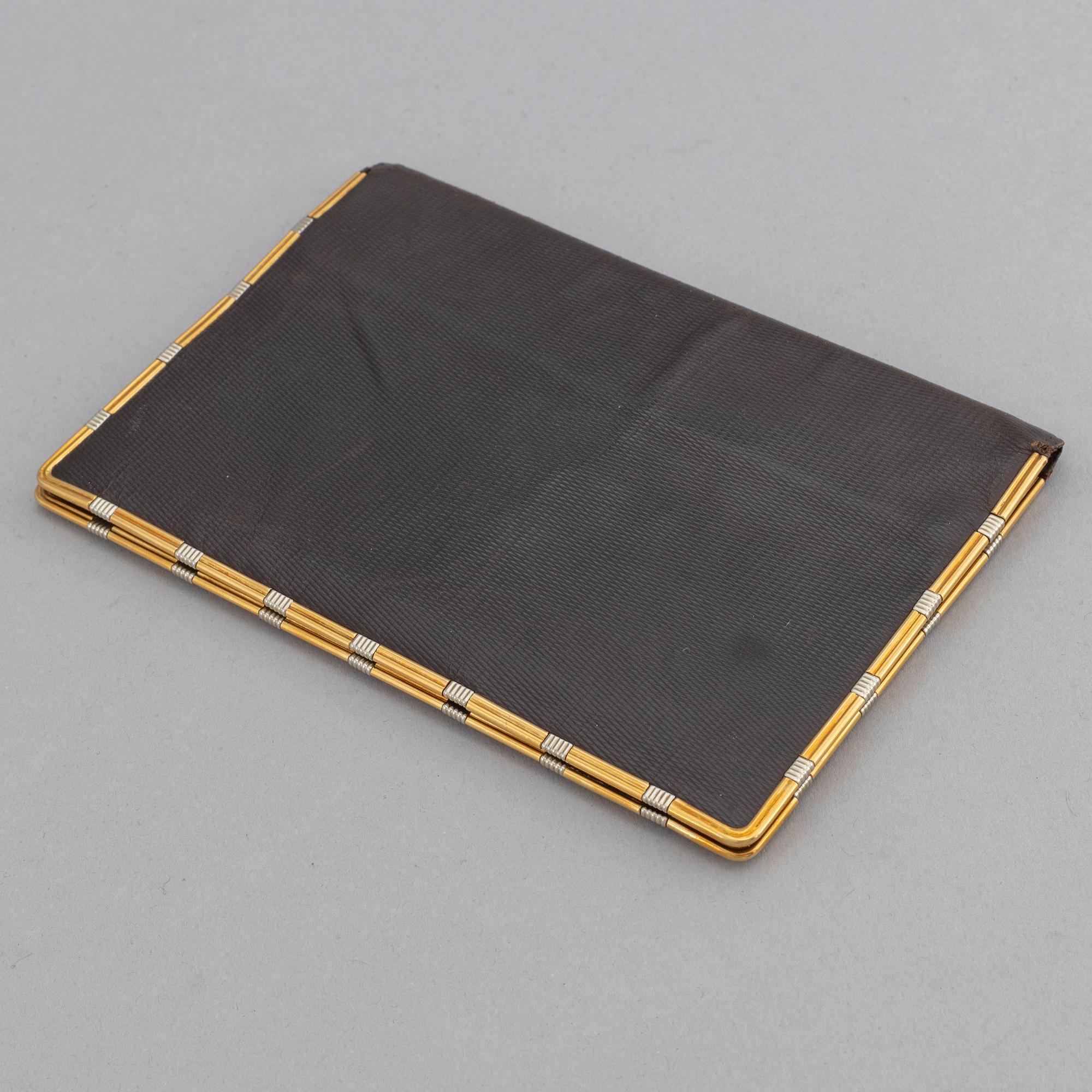Cartier, troligen. Plånbok.