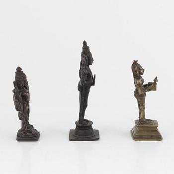 A group of three Indian bronze figures and an ewer, 20th century.