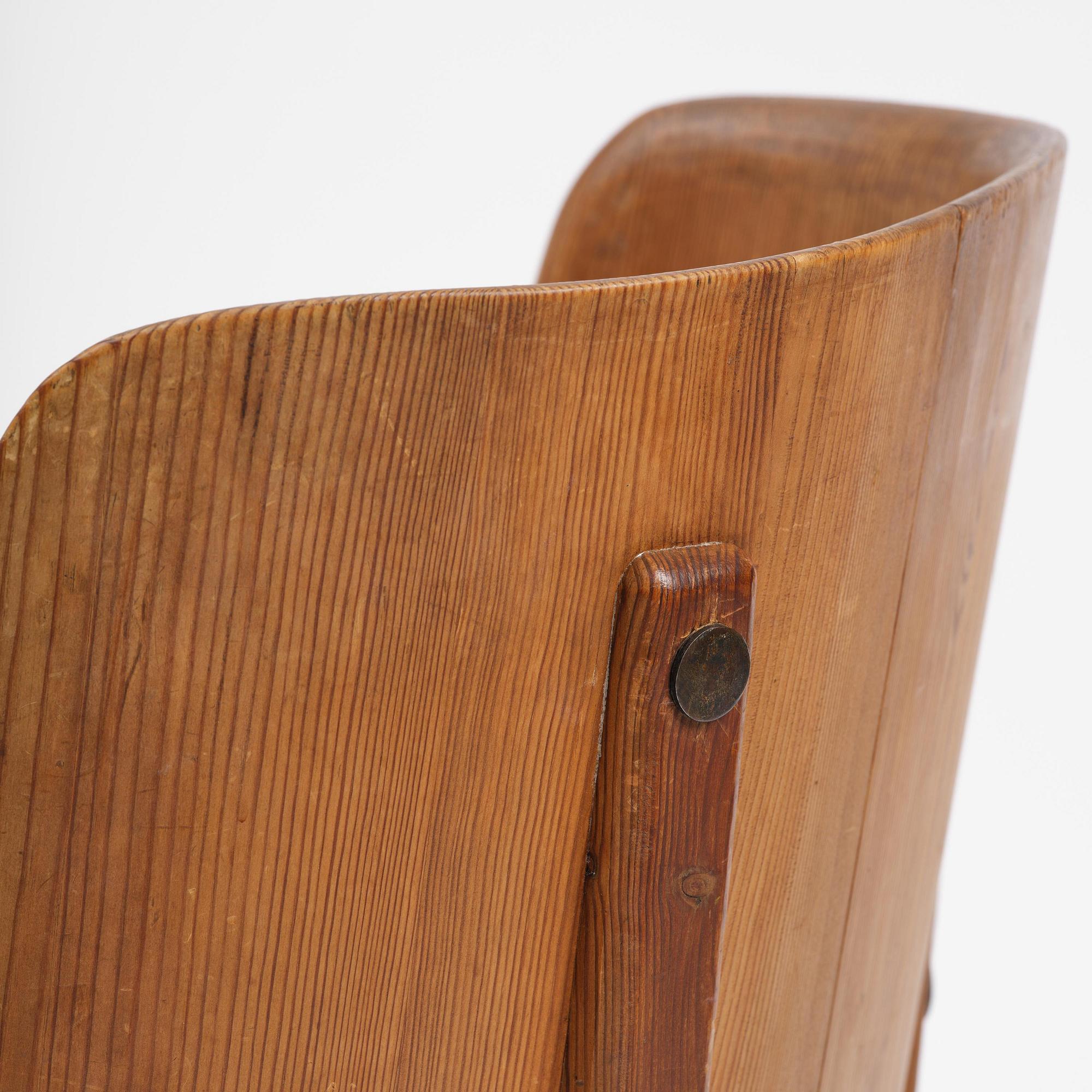 Axel Einar Hjorth, a pair of stained pine "Lovö" armchairs, Nordiska Kompaniet, Sweden, 1930s.