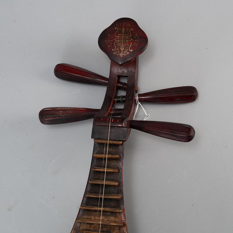 A Chinese wooden 'Pipa'/'flute' musical instrument, 20th century.