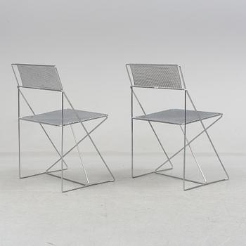 8 contemporary stackable metal chairs.