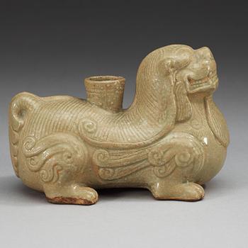 A pale celadon glazed figure of a mythological beast, Six dynasties (222-589).