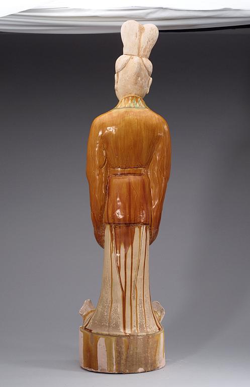 A potted, partially glazed tomb figure of a guardien, Tang dynasty (618-907).