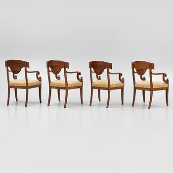 A suite of four Swedish Empire mahogany open armchairs, early 19th century.