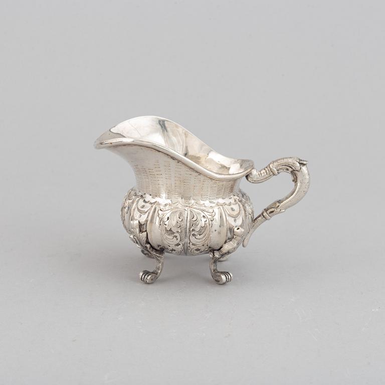 A silver teapot, creamer and sugar bowl, swedish import mark.