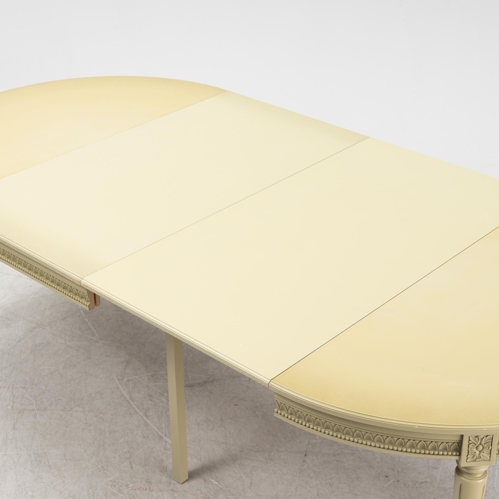 A Gustavian dining table with six chairs. Åmells dated 1974.