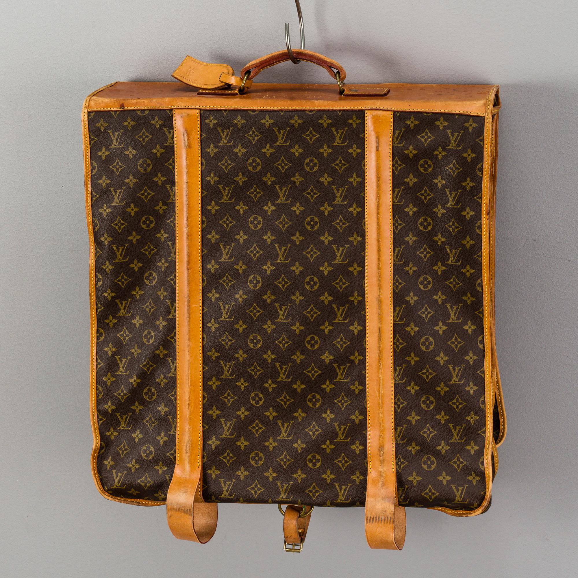 A Louis Vuitton vintage Monogram Canvas Homme Garment Bag.
