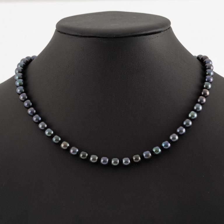 Necklace of cultured freshwater pearls, clasped with 14K white gold and round brilliant-cut diamonds.