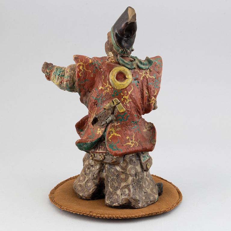 A Japanese pottery figure, 20th Century.