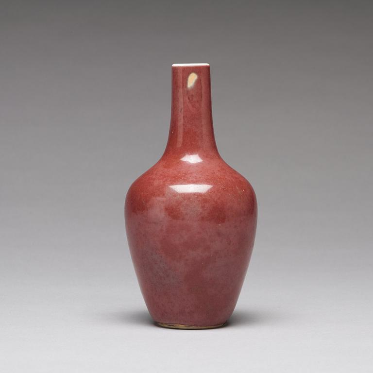 A sang de boef vase and bowl and an enamelled cup with cover and stand, Qing dynasty (1664-1912).