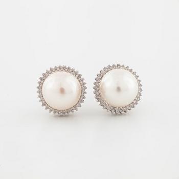 A pair of mabe pearl and brilliant cut diamond earrings.