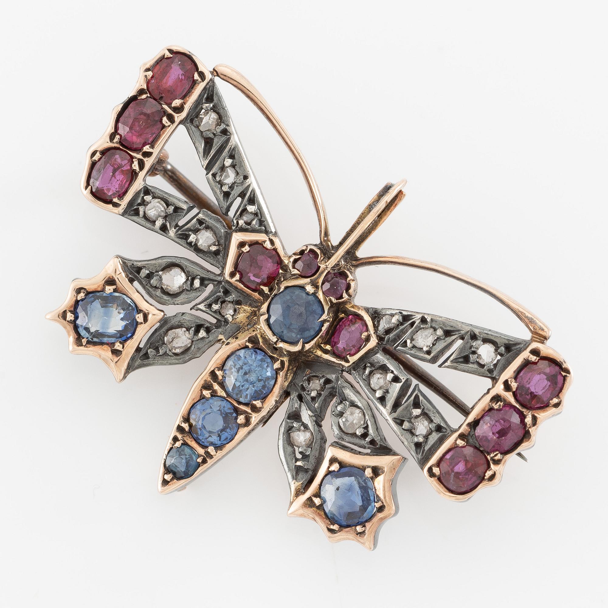 Brooch, in the form of a butterfly, set with sapphires and rubies and rose-cut diamonds.