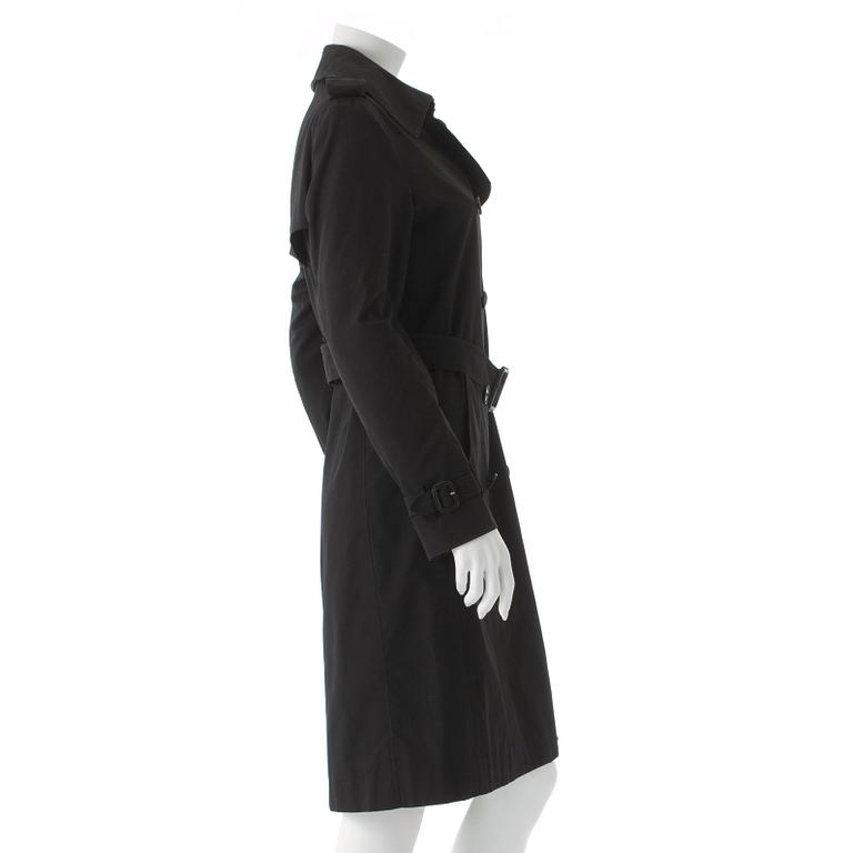 BURBERRY, a black cotton trench coat.