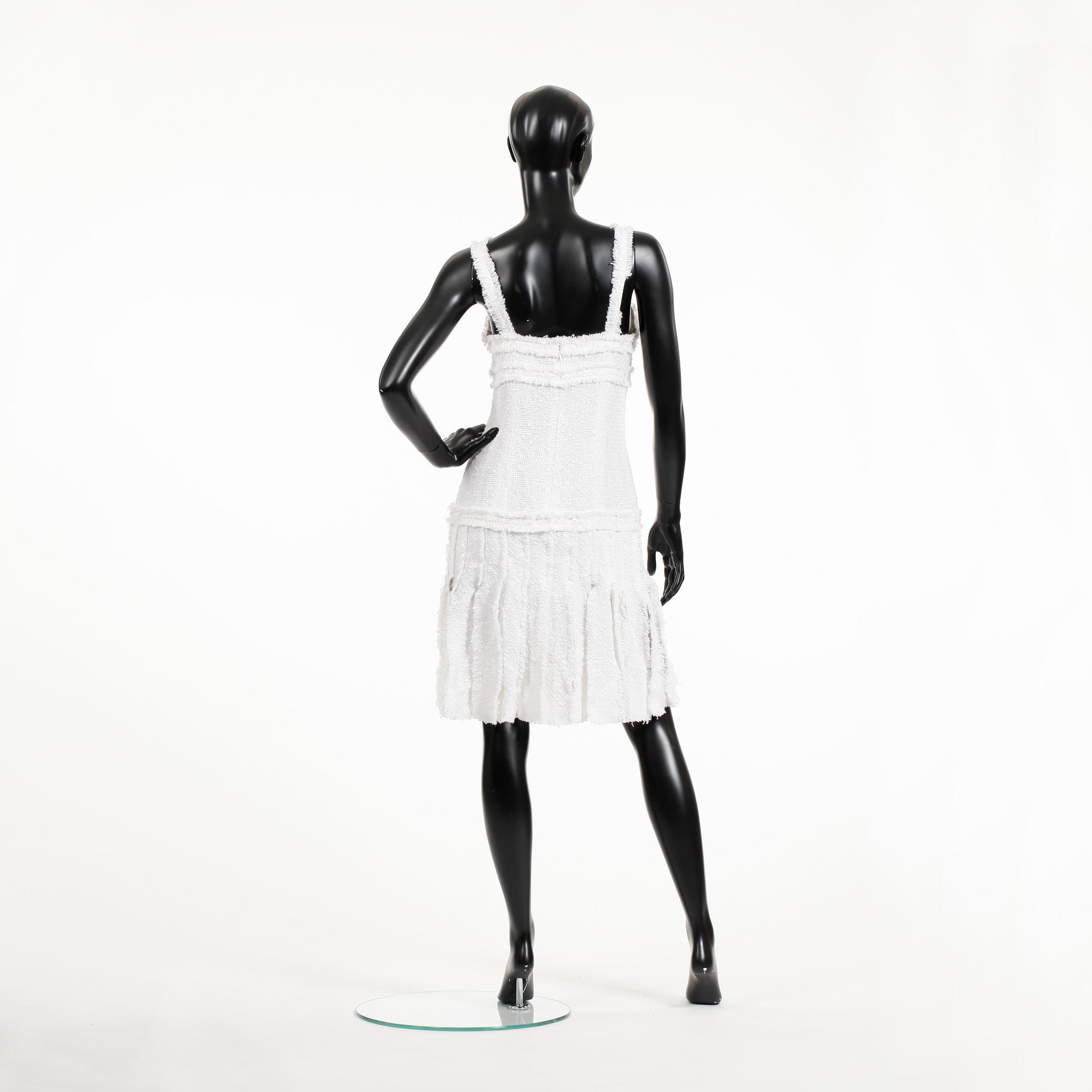 CHANEL, a white bouclé dress, 2004.