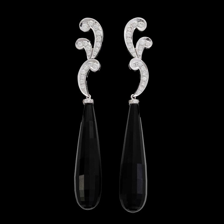 EARRINGS, onyx with brilliant cut diamonds, tot. 0.73 cts.