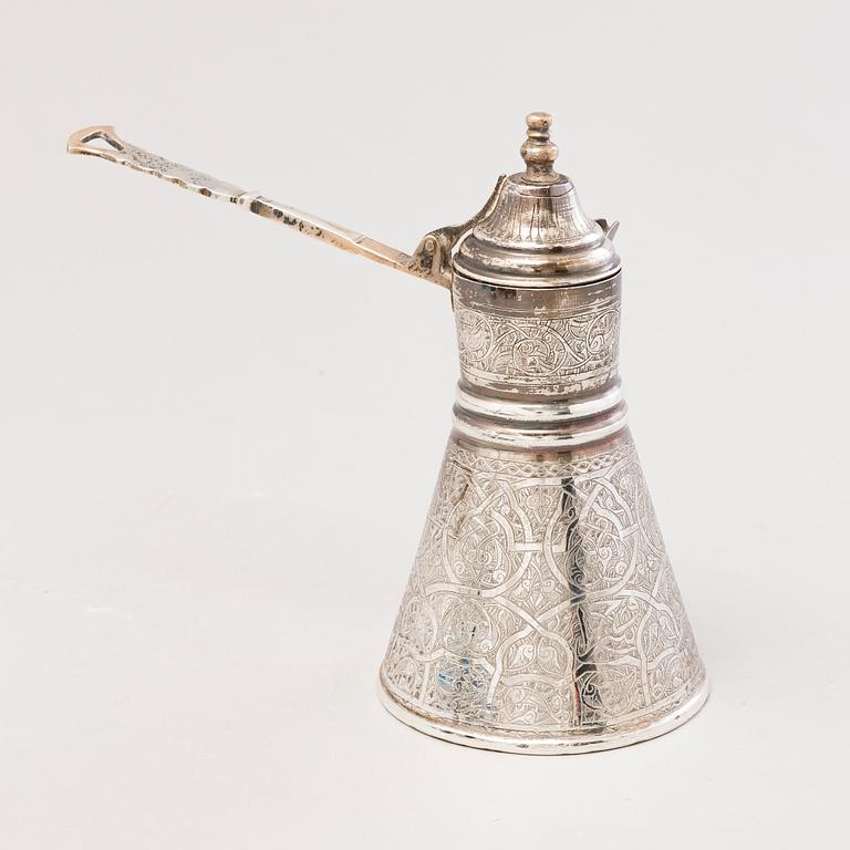 A 1970s Egyptian coffee set in silver and glass.