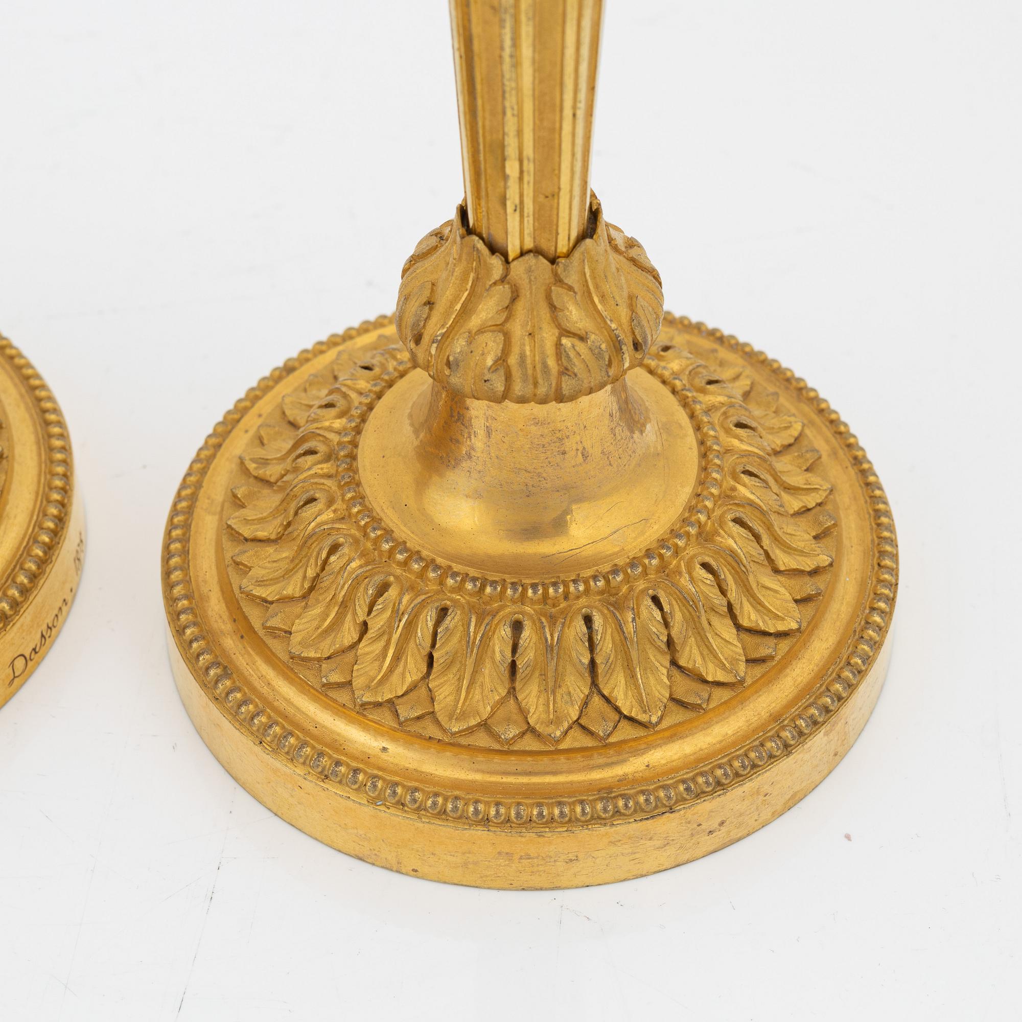 A pair of gilded bronze candelsticks, 19th Century.