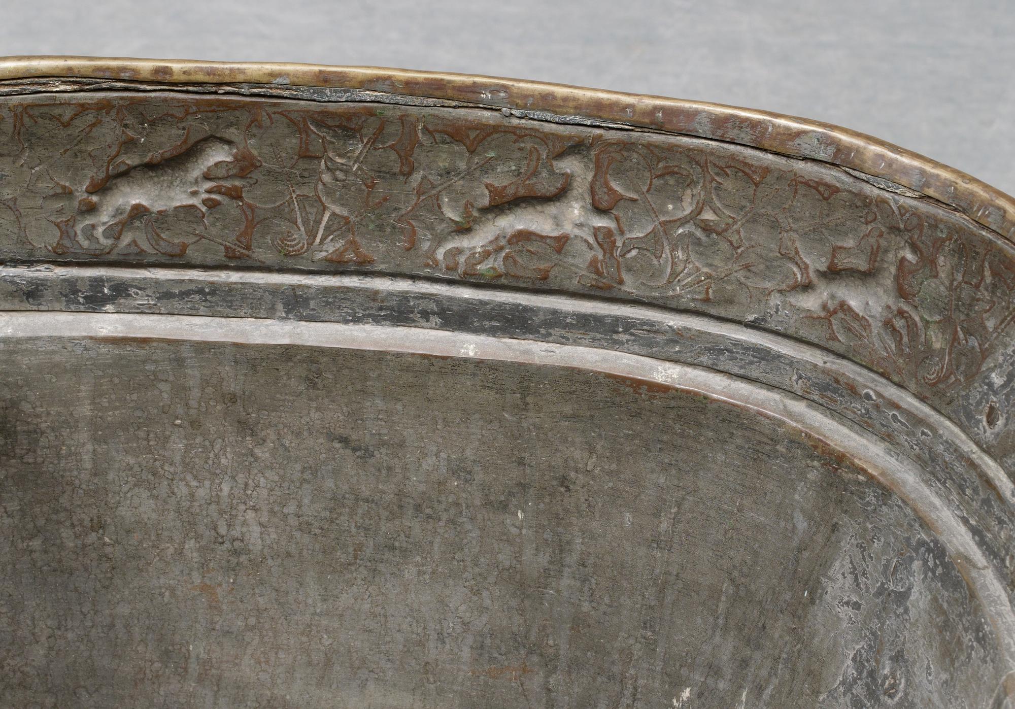 A Baroque brass wine cooler.