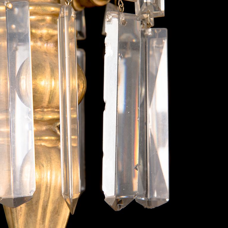 A brass chandelier with prisms, late 19th century. Height 75 cm.