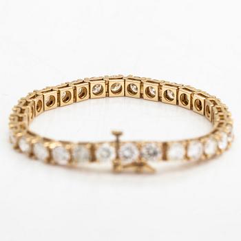 A 14K gold tennis bracelet, with brilliant-cut diamonds totalling approximately 12.00 ct.