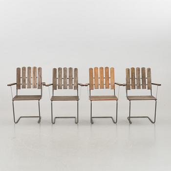 A GARDEN TABLE AND FOUR ARMCHAIRS FORM GRYTHYTTAN.