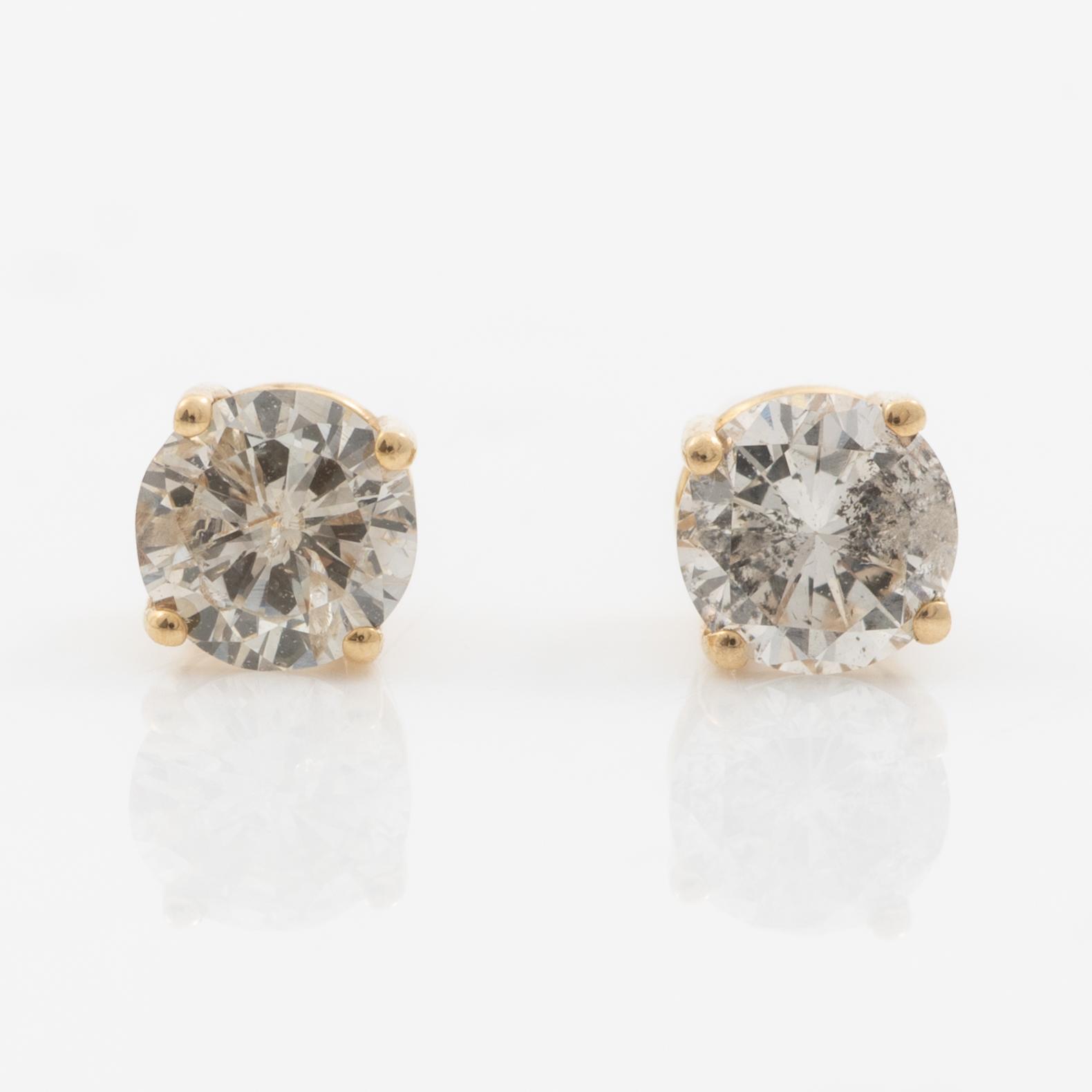 A pair of 14K gold earrings with round brilliant-cut diamonds.