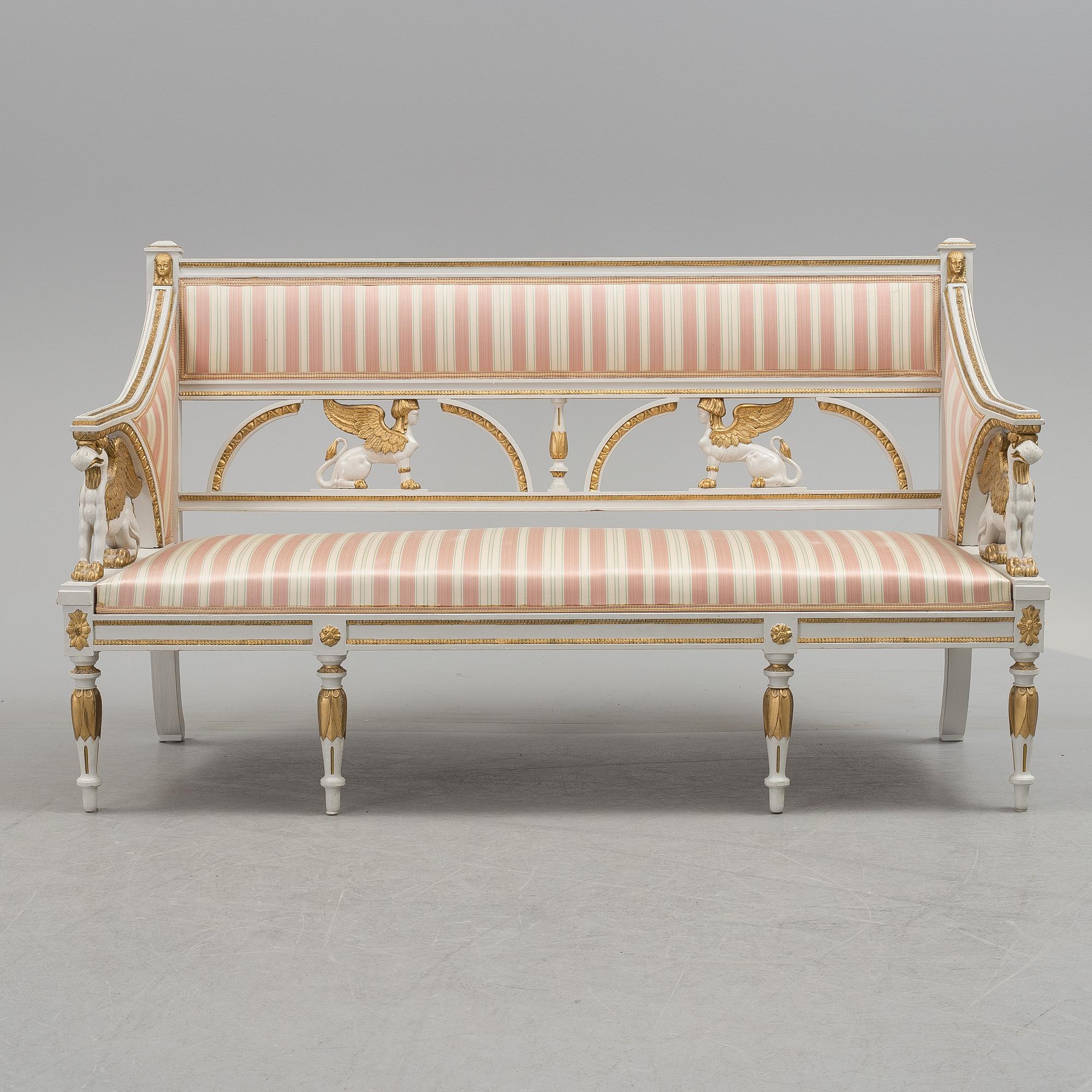 A set of two armchairs, a sofa, a stool and a chair. Early 20th century.