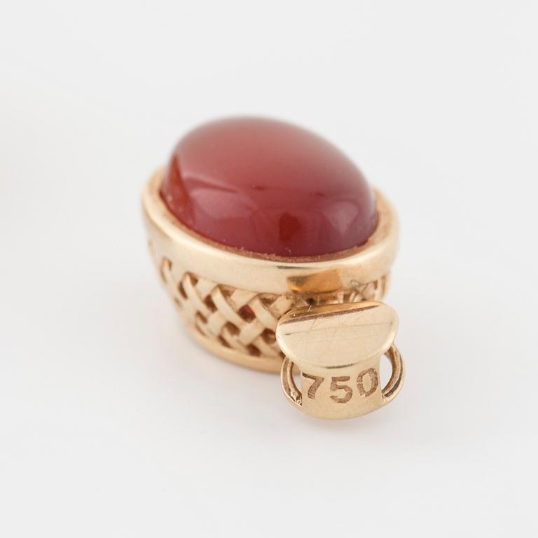 A cabochon cut carnelian ring and brooch.