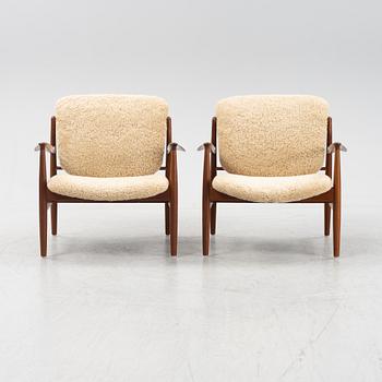 A pair of model FD 136 easy chairs with new sheepskin upholstery by Finn Juhl for France & Son, designed 1958.