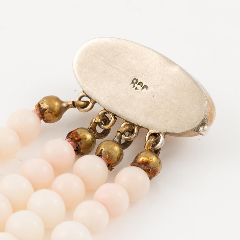 Bracelet with light pink coral, four strands.