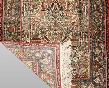 An oriental silk rug, c. 109 x 76 cm.