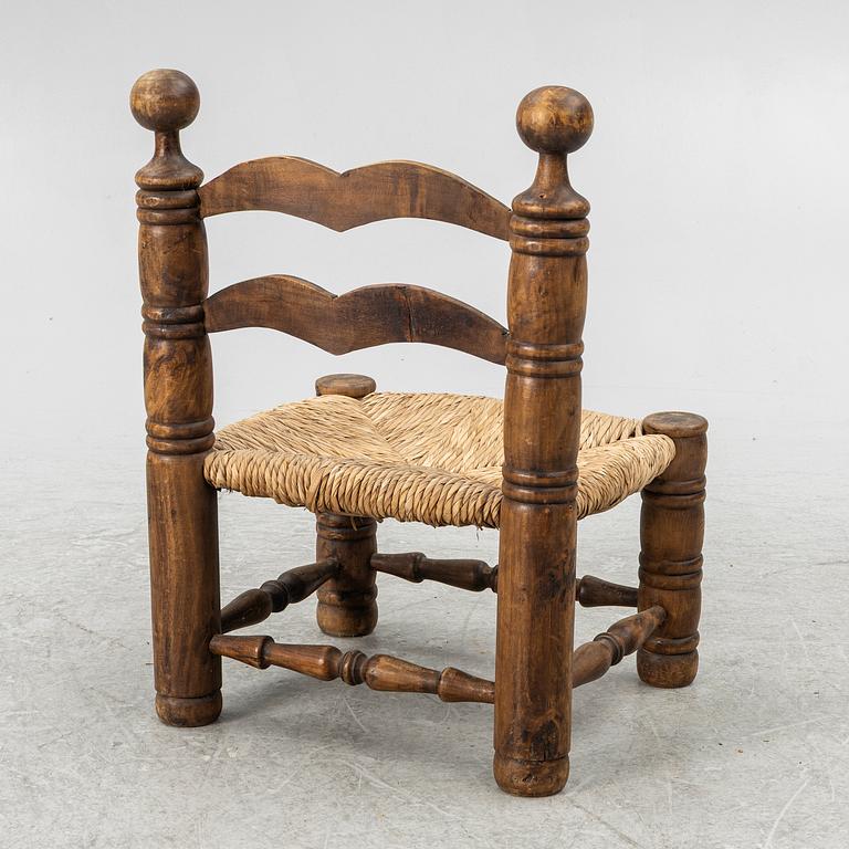Charles Dudouyt, attributed to, a fireside low chair, mid 20th century.