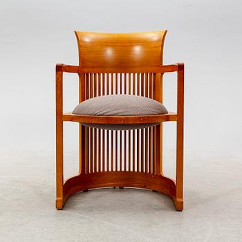 A cherry wood model 606 'Barrel' chair by Frank Lloyd Wright from Cassina.