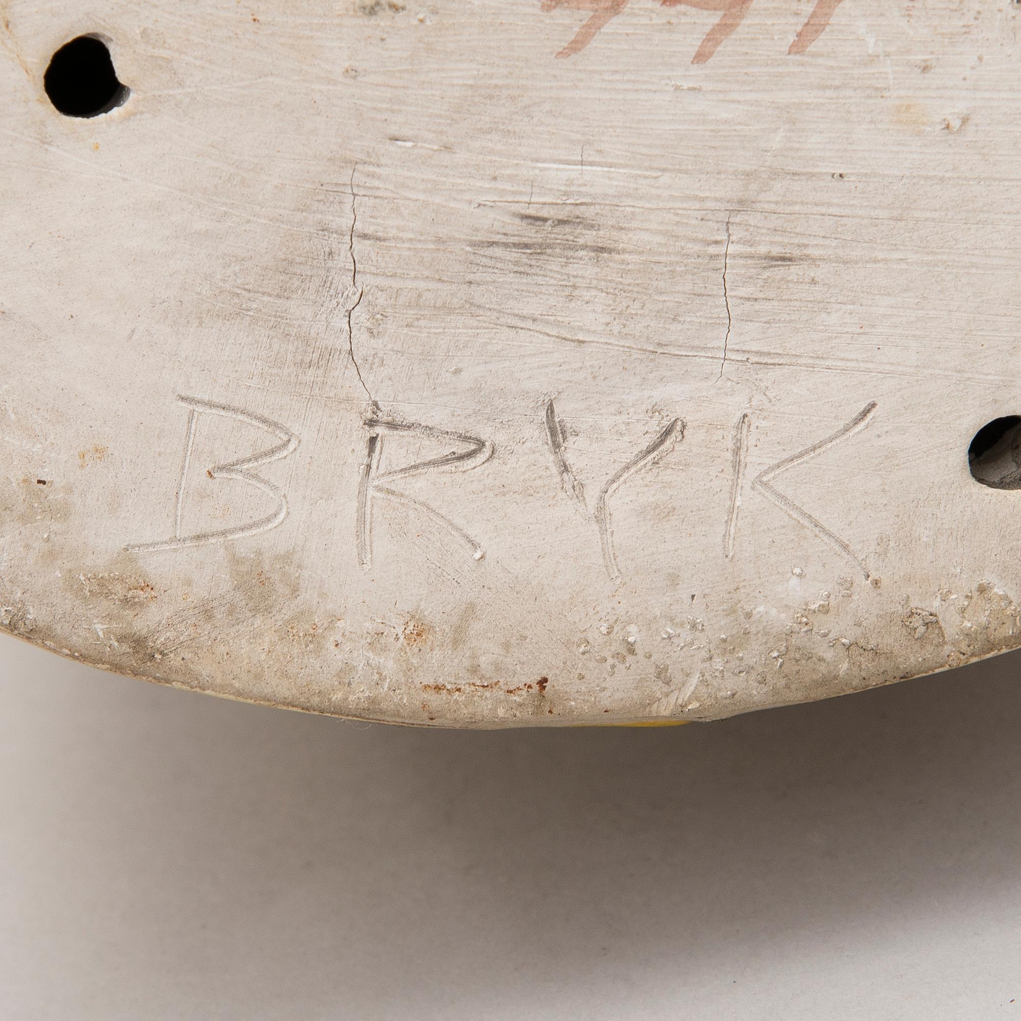 A stoneware figurine signed BRYK.