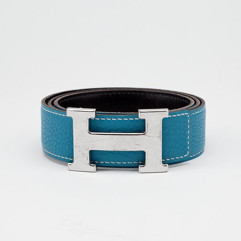 HERMÈS, a reversible belt, blue and brown with silver colored H belt buckle.