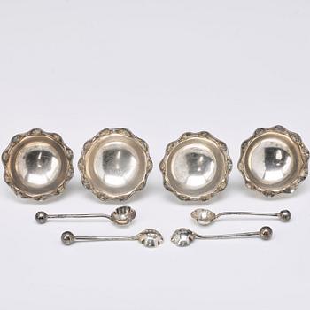 A set of four English silver salt-cellars and sauce-bowl and a dish plated metal.