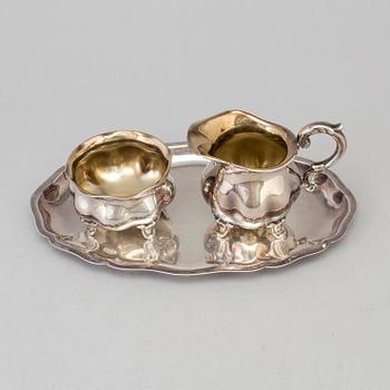 A parcel-gilt rococo style creamer, sugarbowl an a tray from Wilkens, Germany.