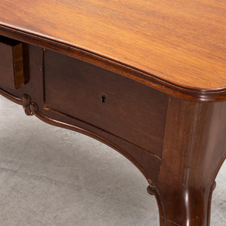 A mahogany Rococo revival desk, late 19th Century.