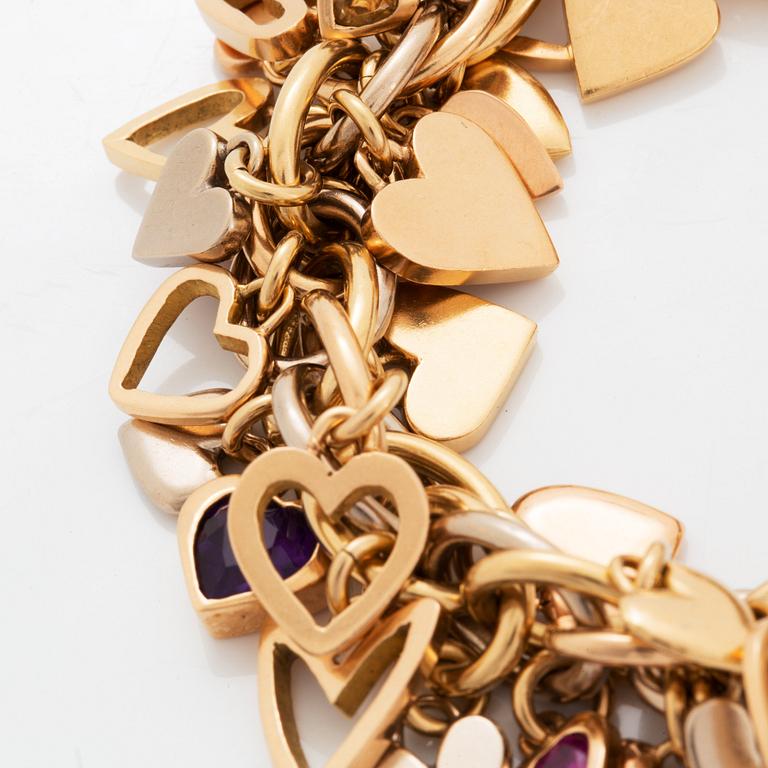 An 18K gold Gaudy bracelet with heart shaped charms.