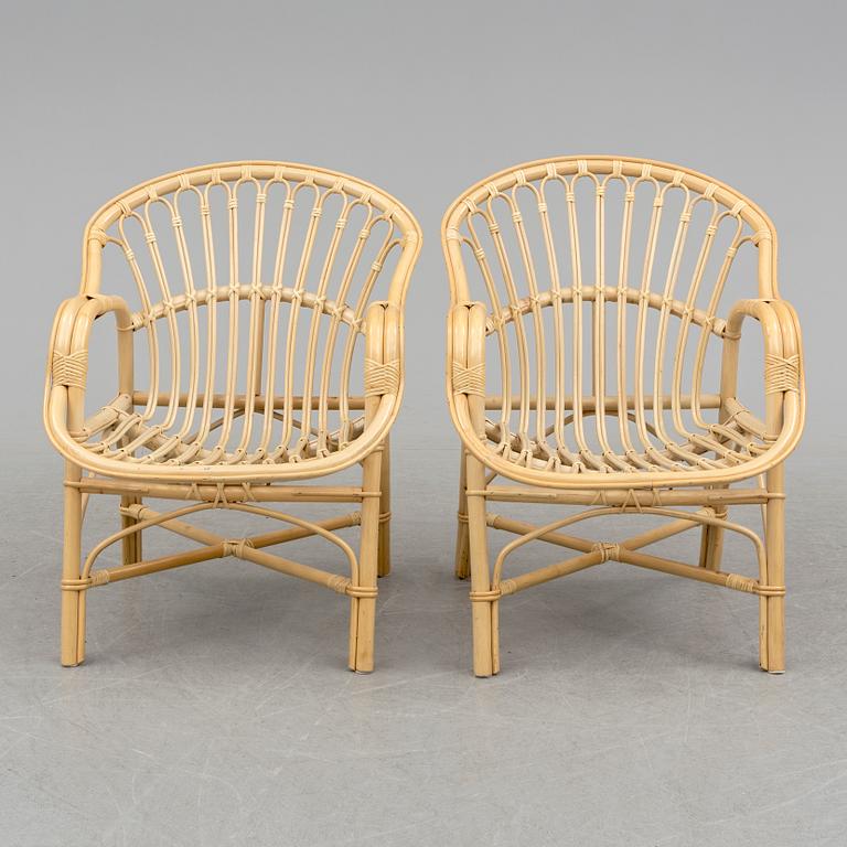 A pair of late 20th century rattan easy chairs.