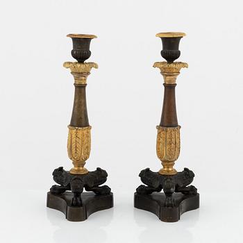 A pair of 19th century empire-style bronze candlesticks.