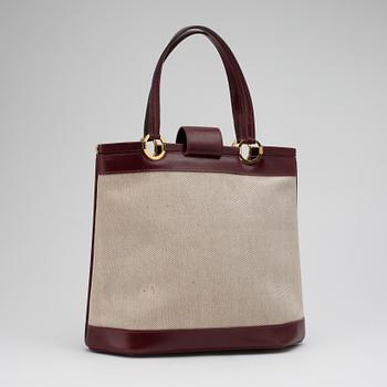 HERMÈS, a canvas and leather handbag.