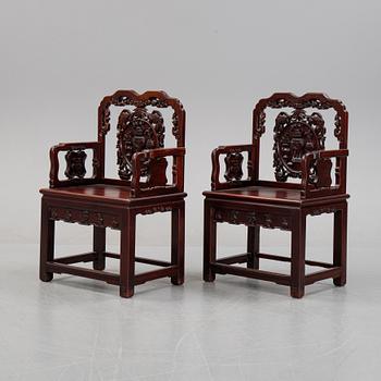 A pair of Chinese hardwood armchairs, presumably late Qing dynasty 19th century.