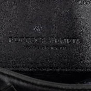 Bottega Veneta, a black intrecciato leather bag.