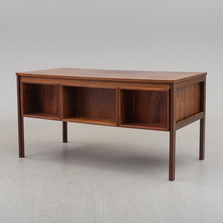 A 1960's/1970's rosewood veneered desk.