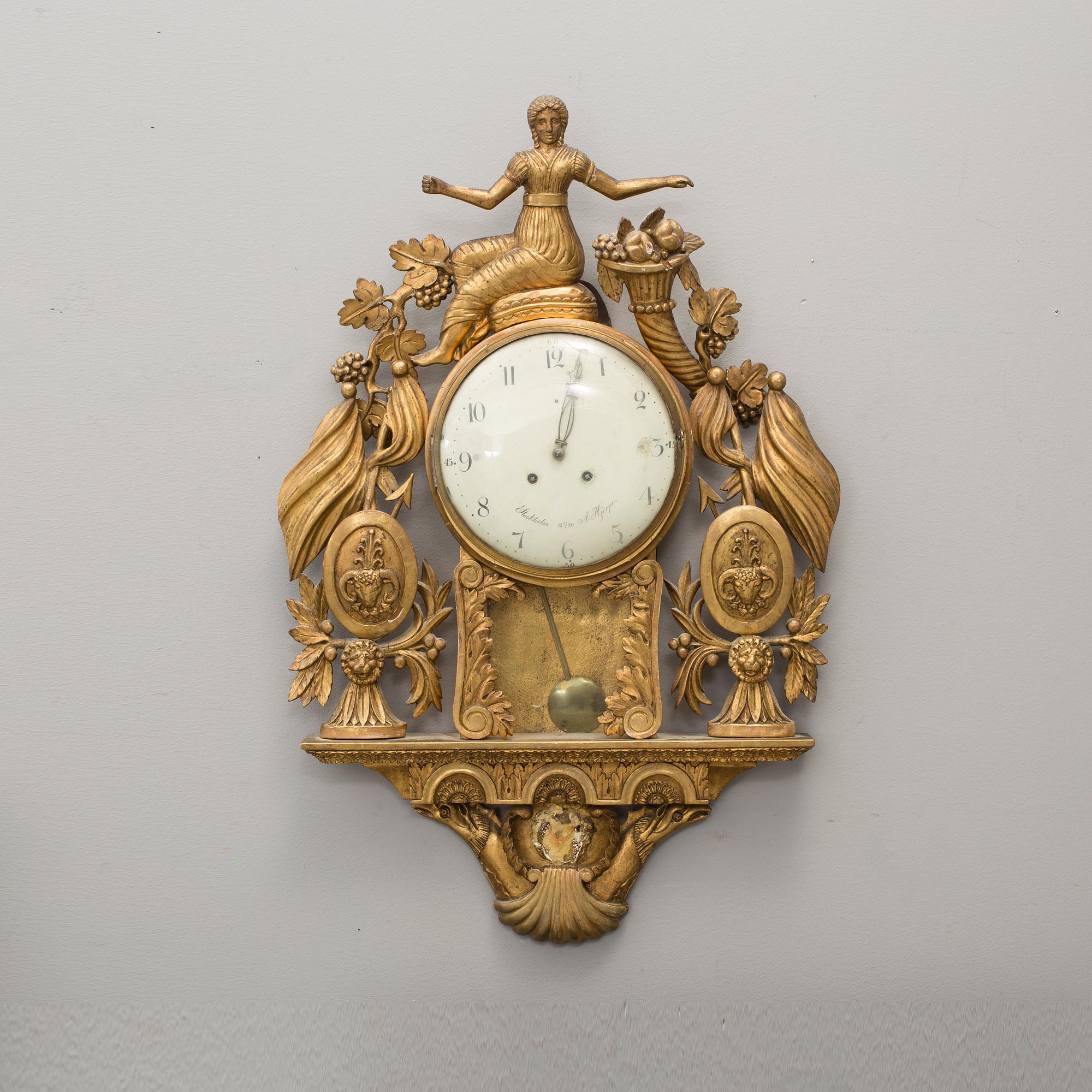 An empire gilt bronze wall clock by Anders Hjerpe, Stockholm, 1820.