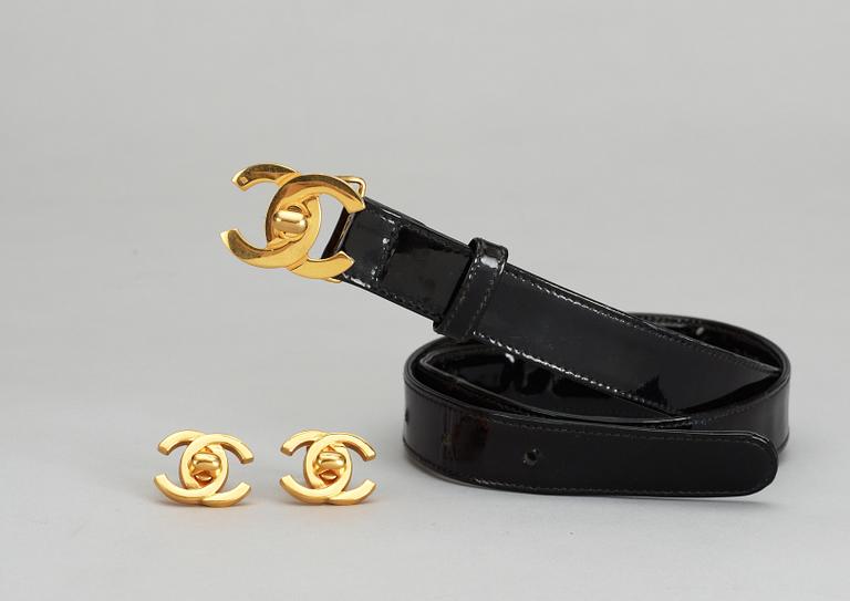 A pair of erclips and a belt by Chanel.