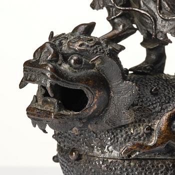 A bronze censer and cover in the shape of  Liu Haichan on the three legged toad, Qing dynasty.