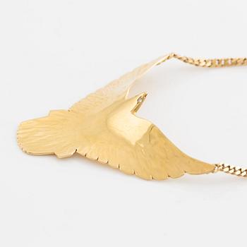 Gold and brilliant cut diamond bird necklace.