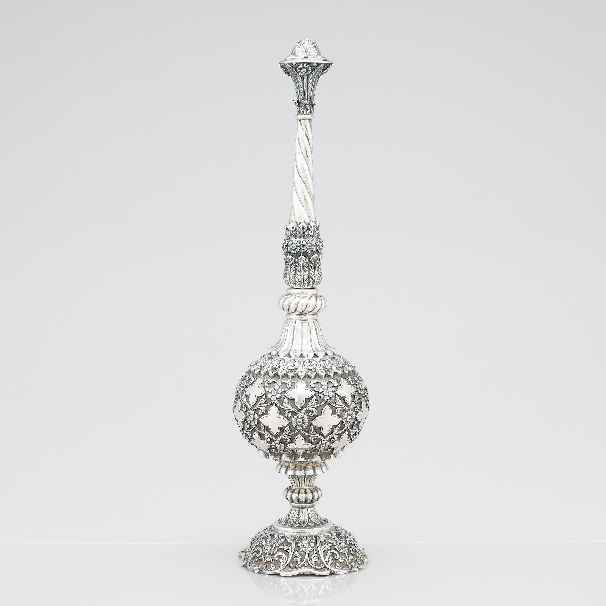 An 1880's british Raj repoussé silver rosewater sprinkler by Oomersi Mawji & Sons.